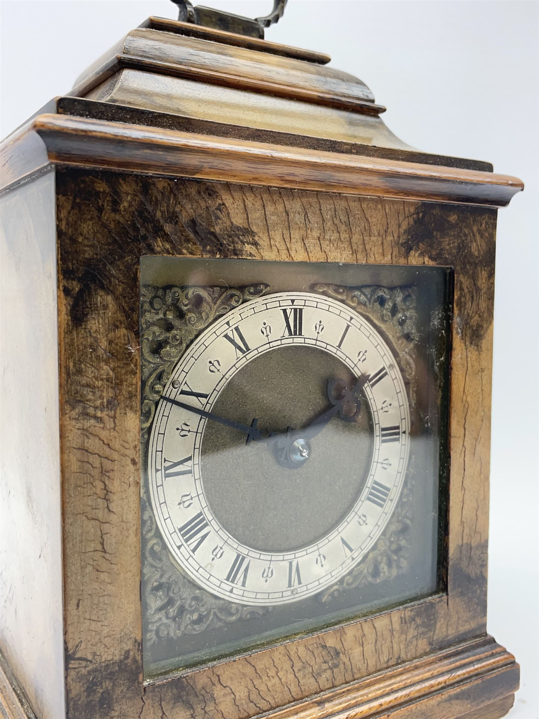 Small late 20th century walnut cased bracket clock. sarcophagus top with brass loop handle, brass dial with silvered Roman chapter ring and ornate spandrels, single train movement by 'Buren'