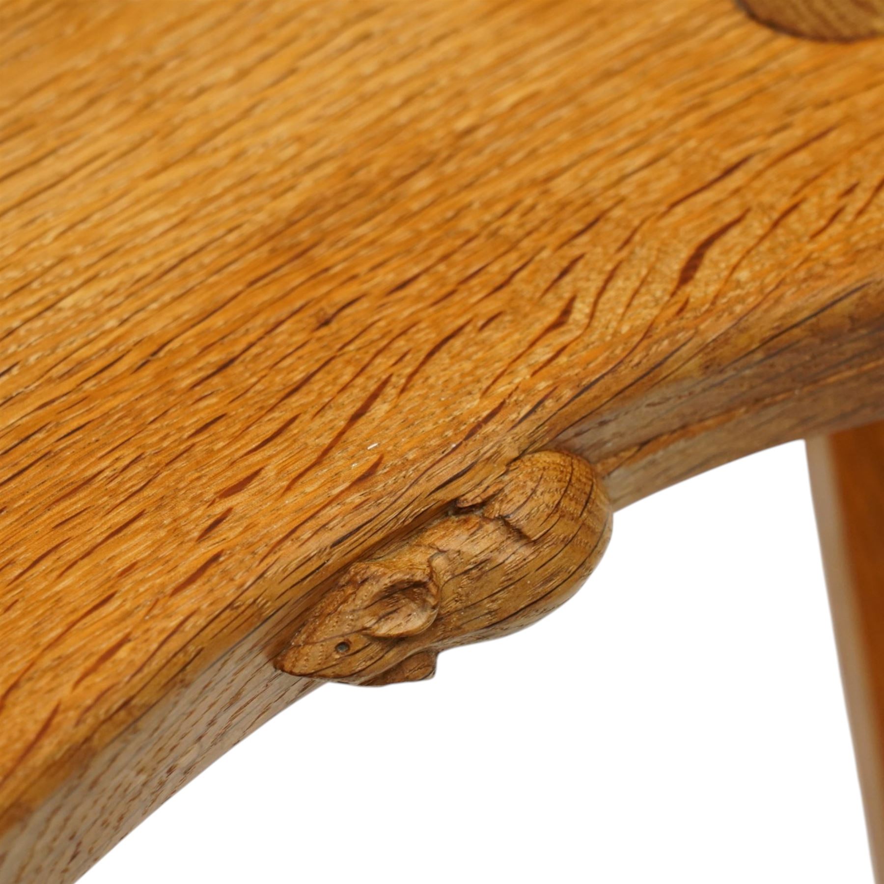 Mouseman - oak three-legged stool, dished kidney-shaped seat, raised on three octagonal splayed supports, with carved mouse signature, by the workshop of Robert Thompson of Kilburn