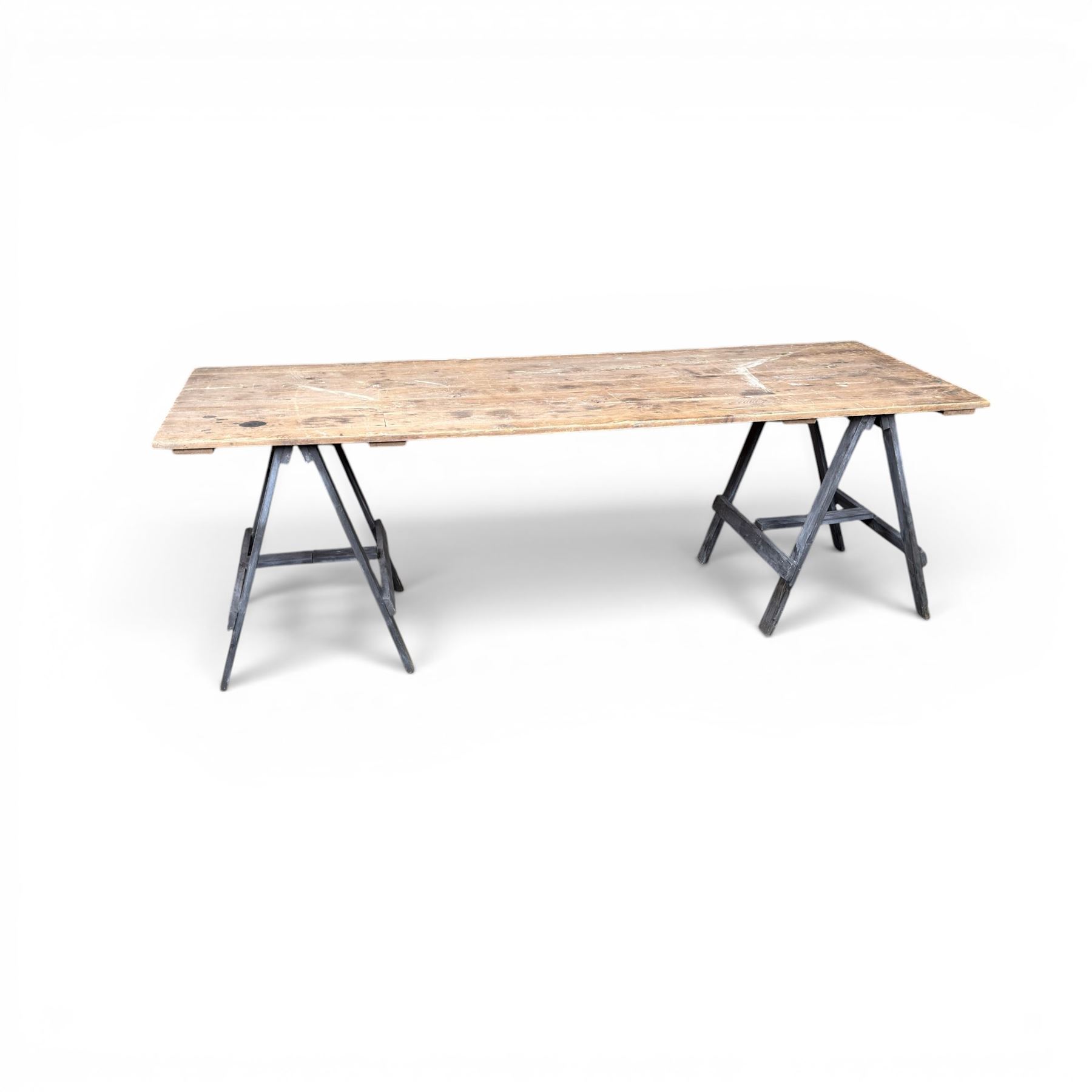 Vintage wooden plank trestle table, on two painted folding stands