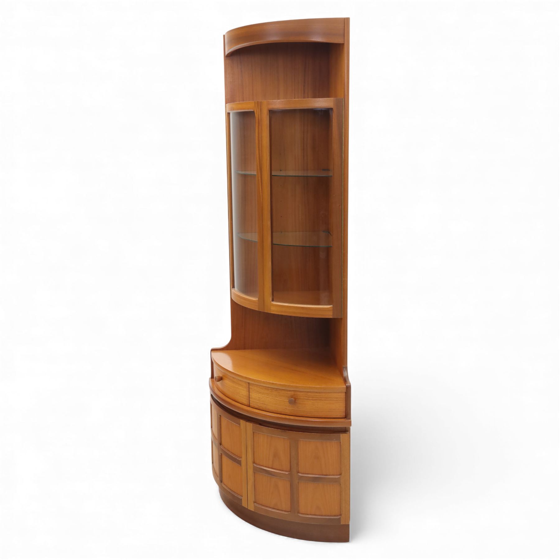 Nathan for Parker Knoll - corner cabinet, the upper section enclosed by two curved glazed doors with glass shelves, over a shaped base fitted with a single frieze drawer and panelled twin cupboard doors