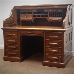  Large late 19th century oak twin pedestal tambour roll top desk, interior fitted with various drawers, correspondence trays and pigeon holes, hinged sides, two slides, nine drawers, plinth base, escutcheon stamped 'Derby Desk, Boston Mass. USA', W155cm, H135cm, D97cm  