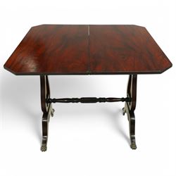 Regency mahogany and ebony inlaid fold-over tea table with reeded edge above spiral reeded centre stretcher on lyre supports with brass star inlaid panel on out swept legs with lion paw brass castors 