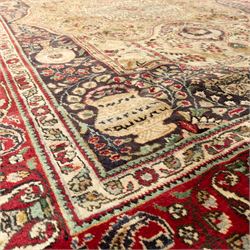 Azerbaijan rug, intricate central medallion in muted golds and greens surrounded by navy panels filled with boteh and floral designs, enclosed by a red main border featuring stylised boteh motifs, woven in the Caucasus region of Azerbaijan