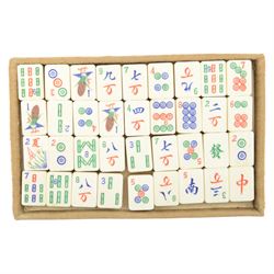 20th century Chinese Mahjong set, with five trays containing bone counters and tiles, contained within a leather bound travelling case with embossed detailing