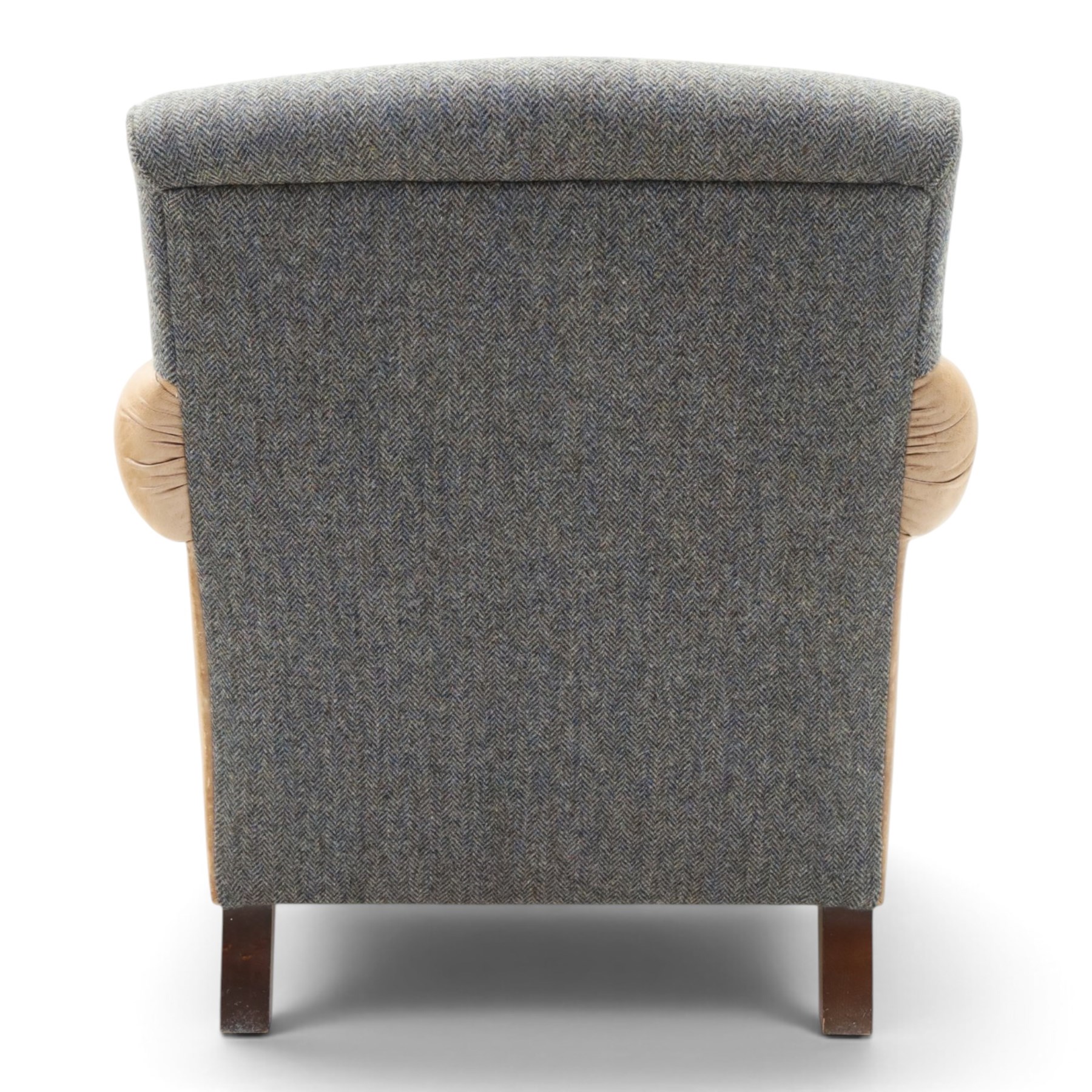 Tetrad - 'Taransay' Harris Tweed and tan leather club armchair, Howard shape with reclined back over deep seat and rolled arms with studwork, raised on turned front supports with castors, the sides and arms upholstered in tan leather with seat and back in herringbone-stitched Harris Tweed