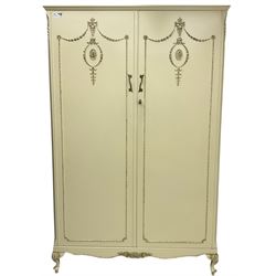 French classic design cream painted double wardrobe, the doors decorated with gilt and cream applied urn motifs with extending bell-flower festoons and ribbon twists, enclosing shelf and hanging rail, shaped apron on acanthus cabriole feet