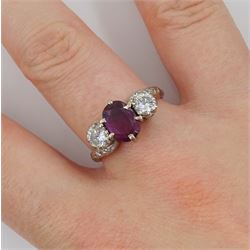 18ct white gold three stone oval ruby and round brilliant cut diamond ring, with diamond set shoulders, stamped, ruby approx 1.15 carat, total diamond weight approx 0.55 carat, in silver top ring box by The Victorian Ring Box Co, Edinburgh 1993 
