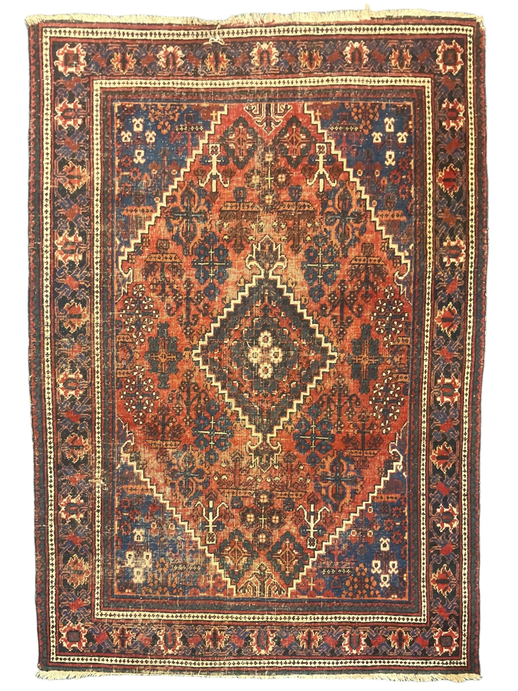 Persian Hamadan red ground rug, the field decorated with floral motifs with central lozenge medallion, guarded border decorated with repeating stylised plant motifs