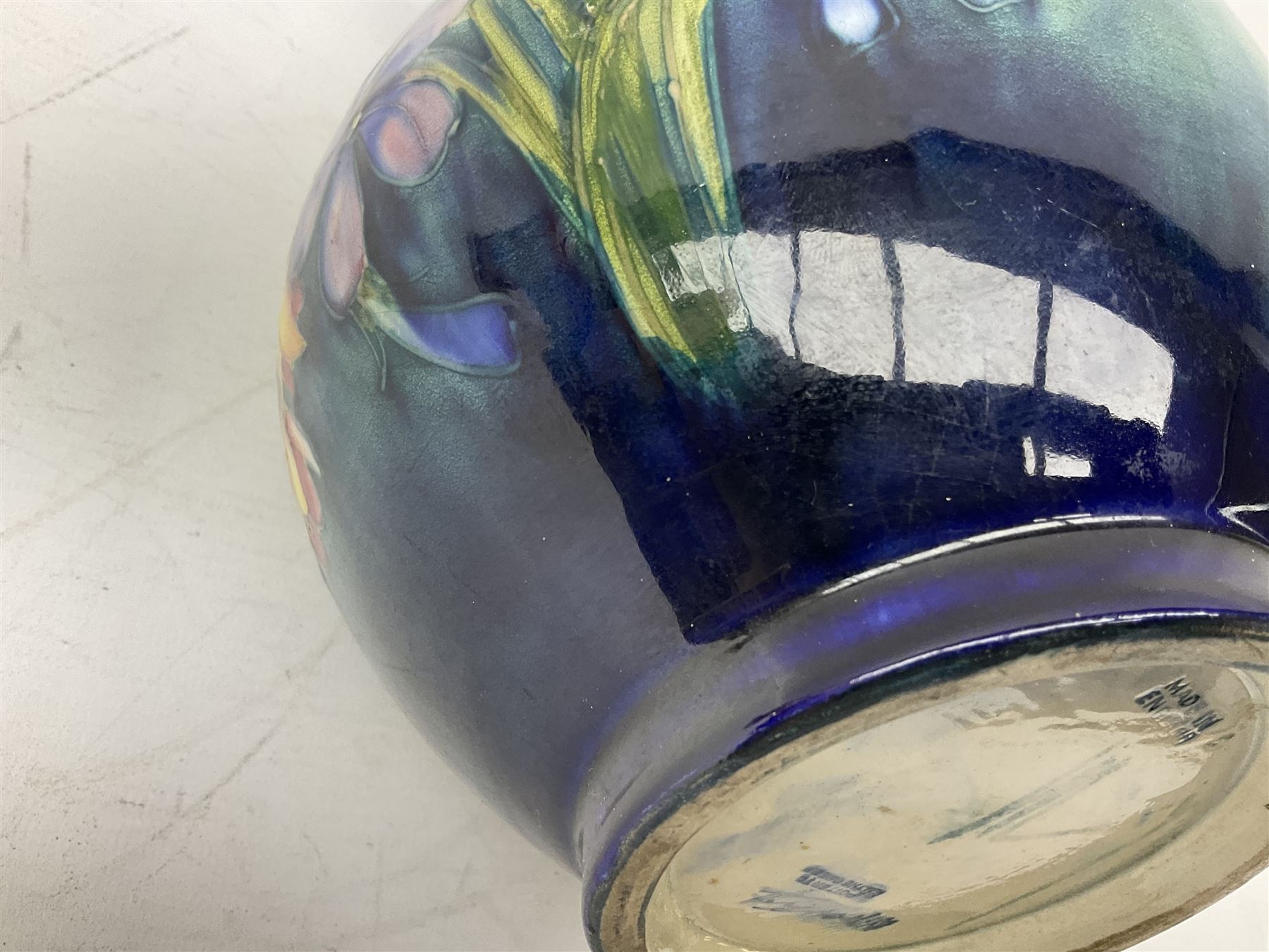 Moorcroft vase of baluster form decorated in the Spring Flowers pattern upon a merging green and blue ground, with impressed and painted marks beneath, H22.5cm