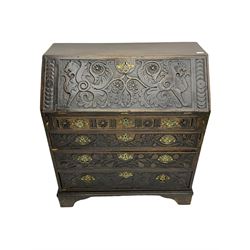 19th century carved oak bureau, fall front above three drawers