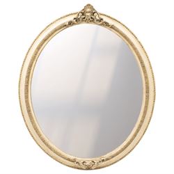 Early 20th century cream and parcel-gilt oval wall mirror with mer-putti pediment