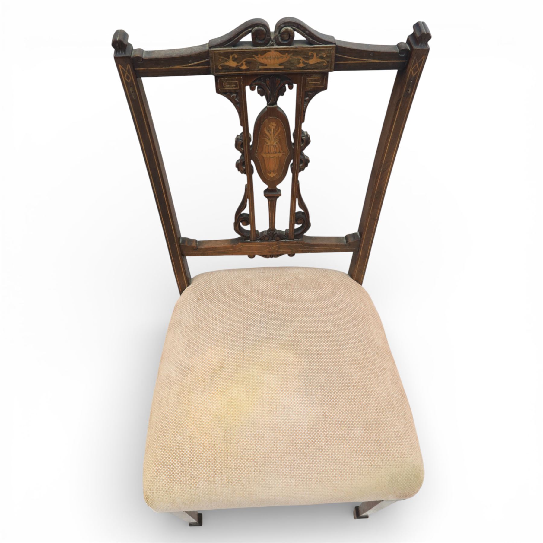Quality Edwardian seven piece inlaid salon suite, comprising three seater settee, pair of arm chairs and four chairs with pierced splat backs, upholstered in pale pink fabric, inlaid with flowering urns, upon tapering legs with spade feet and castors