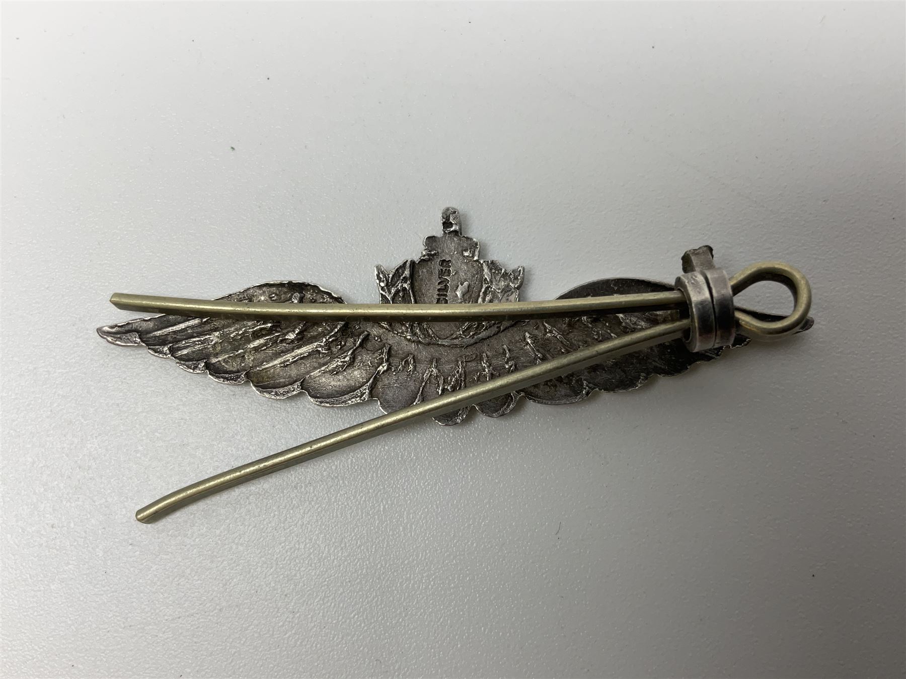 Popski's Private Army sterling silver cap badge; and two silver sweetheart brooches for Highland Light Infantry as a rifle and silver gilt Glengarry badge and Army Service Corps with blue enamel; and another silver badge (4)