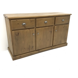 Solid pine dresser base, three drawers above three cupboard doors, two slides to side, shaped plinth base, W140cm, H81cm, D46cm  