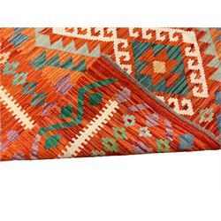 Anatolian Turkish Kilim amber ground rug, the field decorated with four lozenges with ivory outline, the double banded orange border with repeating geometric patterns 