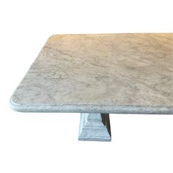 Classical Grecian design Carrera marble centre table, the rectangular single slab top with rounded corners and carved edge, raised on twin pedestals comprised of three pieces with a waisted column on a stepped plinth