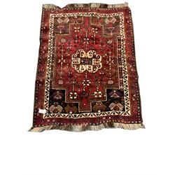 Shiraz red ground rug, central medallion, repeating border