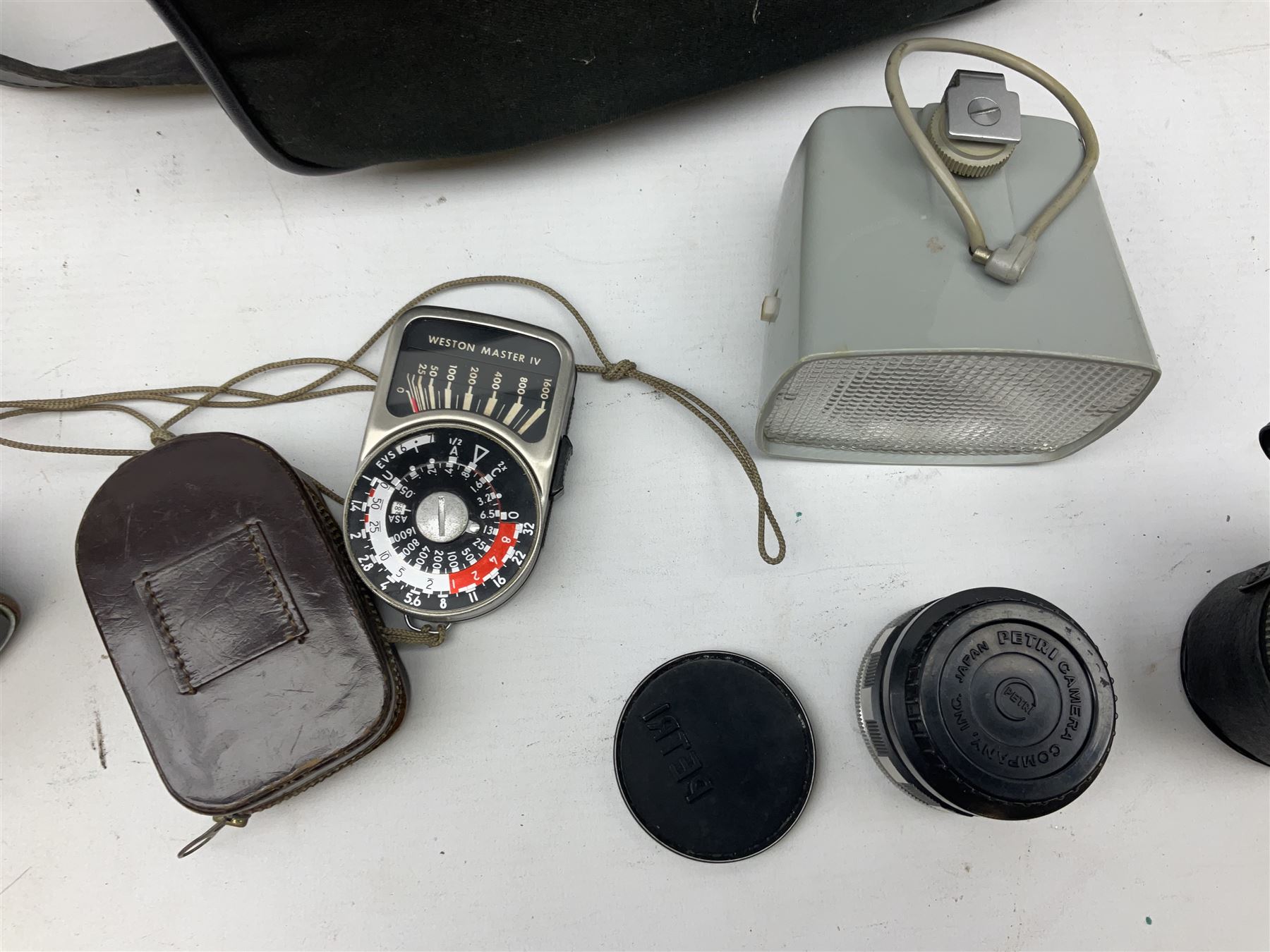 Petri FT 35mm SLR camera with a Petri 1:1.8 55mm lens, Petri Flex camera with a Petri 1:2 55mm Kuribayashi lens, together with cases and quantity of lenses etc