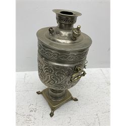 Middle Eastern pewter Samovar, the twin handled body with repousse decorated with scrolling foliage, on quad base, H56cm