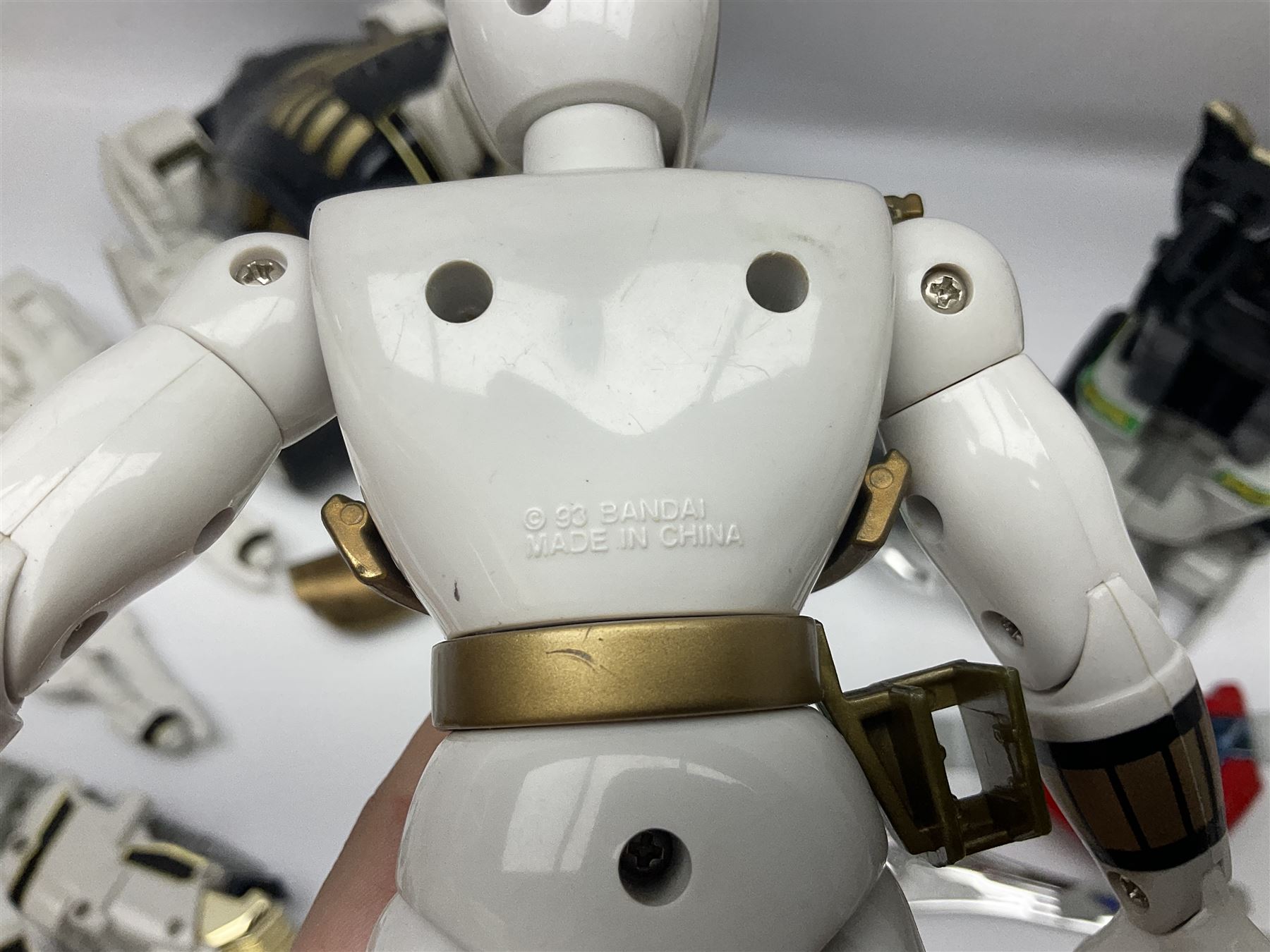 Collection of early 90s Mighty Morphin’ Power Rangers Zords, figures and accessories. Titanus the Carrier Zord, marked Bandai 1991; Green Dragonzord, incomplete; 1994 White Tigerzord with original instruction manual; 1993 Triceratops Dinozord, Mastodon Dinozord and Sabertooth Tiger Dinozord, Pterodactyl Dinozord, missing guns; with 1993 Power Morpher and original Power Coins, with further related figures, accessories and weapons