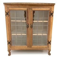 David 'Oakleaf man' Langstaff of Easingwold Yorkshire oak cabinet, egg and dart detailing, with two lead glazed doors enclosing two shelves, bearing oak leaf signature, cabriole claw feet