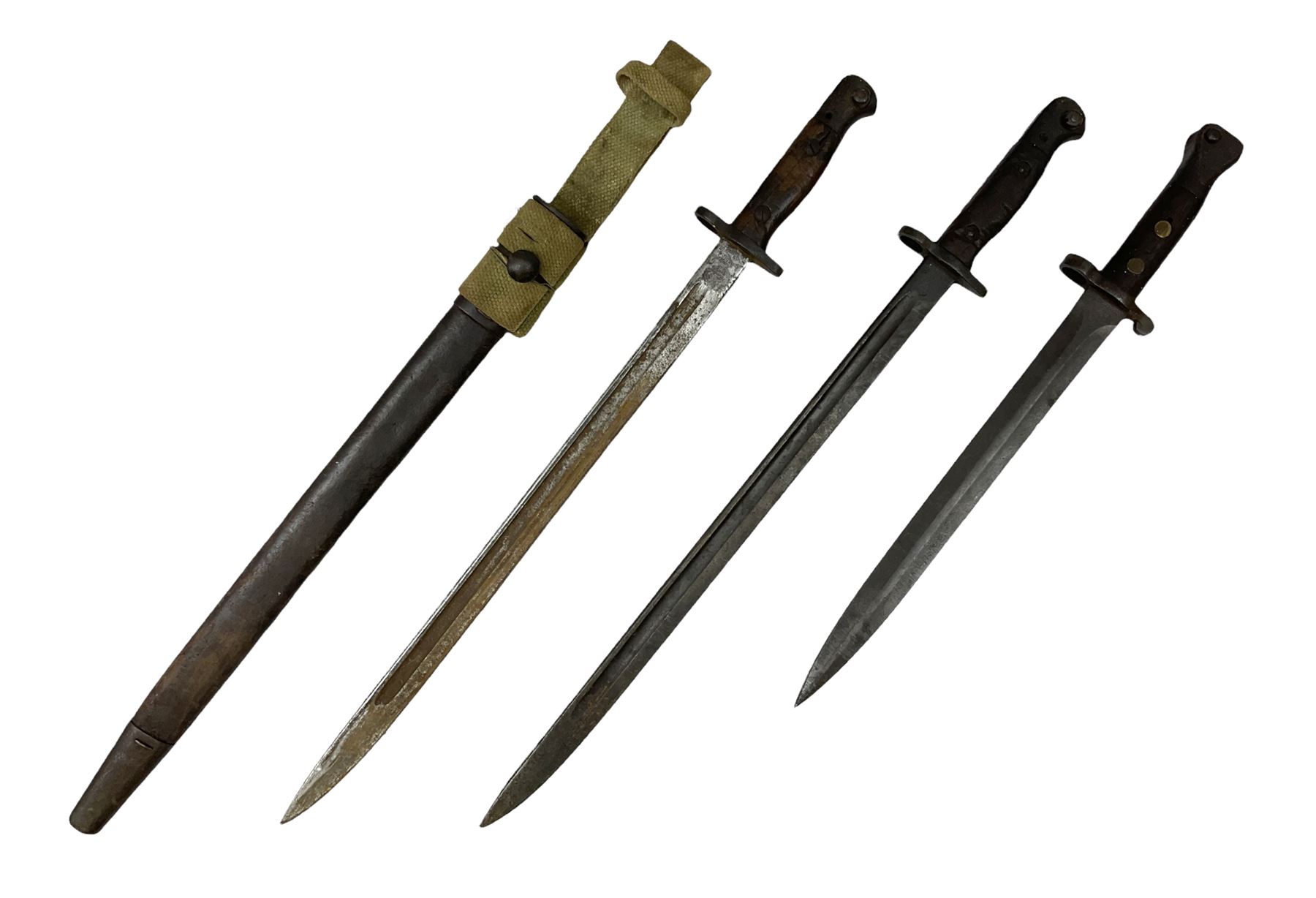 British Pattern 1907 bayonet with 43.5cm fullered steel blade; in leather scabbard with webbing frog L58cm overall; another Pattern 1907 bayonet lacking scabbard; and British Pattern 1888 Mk.I bayonet by Wilkinson London (no scabbard) (3)