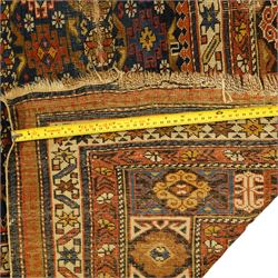 Two antique Caucasian Shirvan rugs, indigo field decorated with horizontal bands of small geometric floral and star motifs within multiple finely drawn borders featuring diamonds, rosettes, and stylized leaves in a palette of madder red, ivory, ochre, and pale blue, with fringe ends, 195x137cm, together with a similar smaller rug, 143x96cm