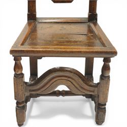 17th century oak and elm hall chair, the high-back with shield-shaped fielded panelling flanked by turned uprights, over a panelled seat, raised on turned supports united by H-stretcher with moulded serpentine front-stretcher