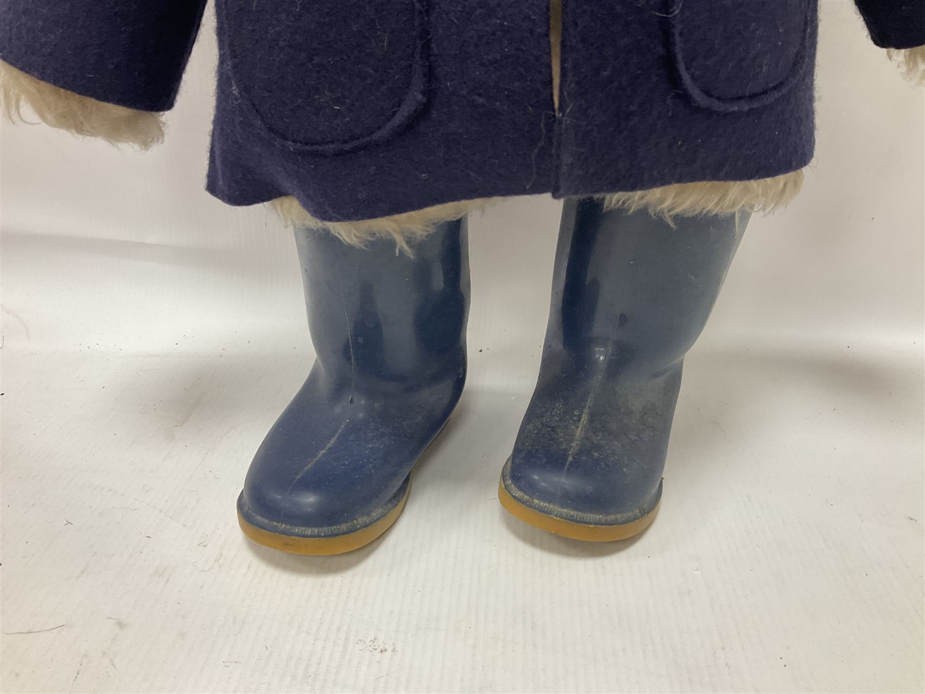 Pair of Paddington Bear teddies with amber eyes, the first example having a brown felt hat, red coat and blue PB boots with original label; the second having a grey felt hat, blue coat and blue Dunlop boots, tallest H51cm 