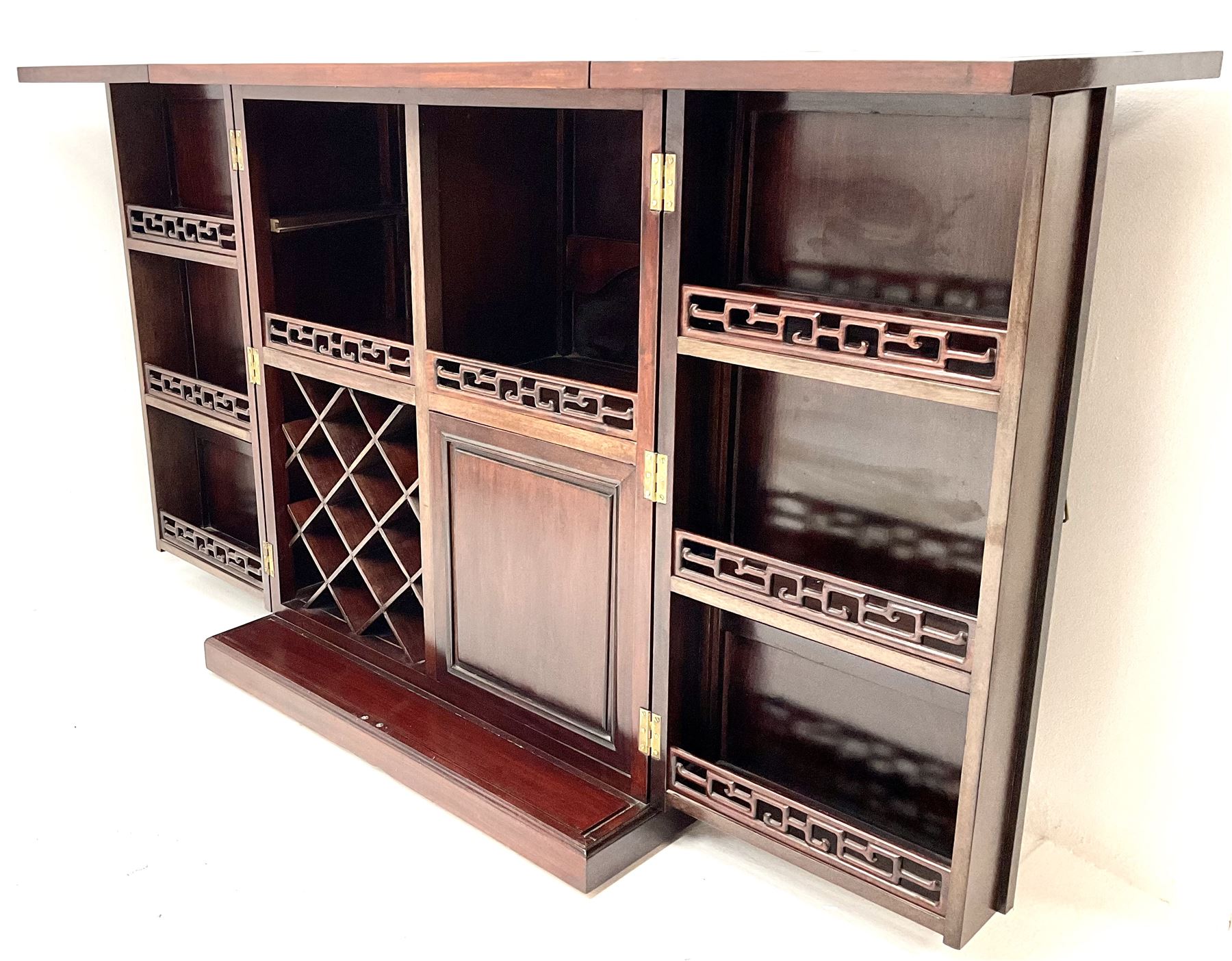 Chinese rosewood cocktail bar, hinge folding top, above two cupboard doors enclosing fitted interior, platform base