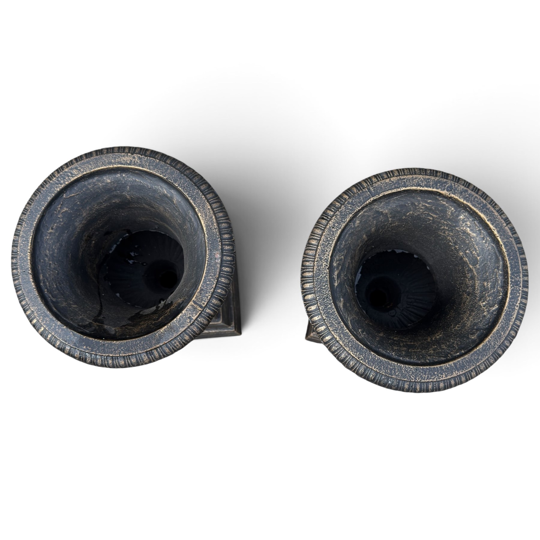 Pair of Neoclassical design black and gilt painted cast iron garden urns of campana form, with egg-and-dart rims and fluted bodies, on knopped stems, fluted socles and stepped square plinth bases