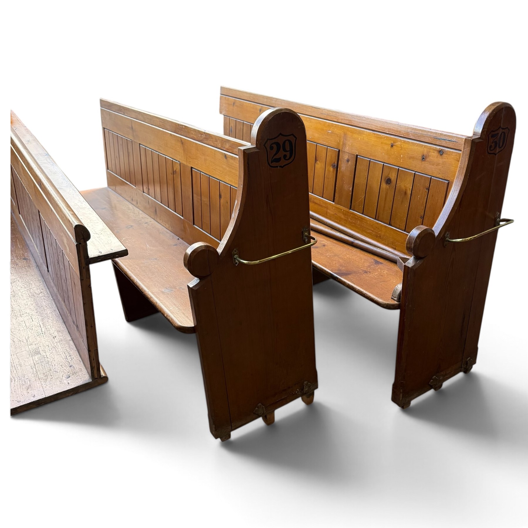 Set of four early 20th century single-ended stained pine ecclesiastical church pews, the shaped end support flanking slatted and panelled back