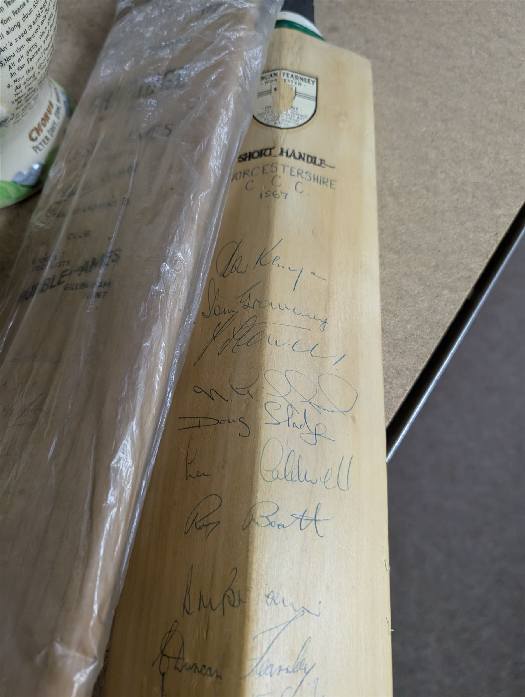 Two signed cricket bats, with signatures including Colin Cowdrey
