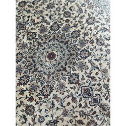 Persian Kashan ivory ground carpet, the field decorated with interlacing foliate branches and stylised plant motifs, scrolling border decorated with repeating palmettes, within floral pattern guard bands