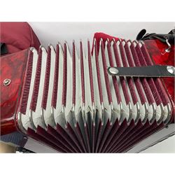 Hsinghai Studio piano accordion with red pearline finish, twenty keys and seventy-two buttons W44cm; in hard carrying case with additional The Music Room soft gig case