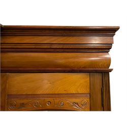 Edwardian walnut combination breakfront triple wardrobe, projecting cornice over cushioned and fluted frieze, central fielded panelled cupboard carved with foliate decoration above two short and three long drawers, flanked by two bevelled mirror doors enclosing hanging hooks with single drawers to base, retailed by J Tonks & Sons, Scarborough