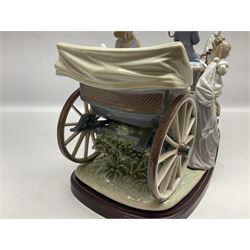 Large Lladro figure, The Landau Carriage, modelled as a horse drawn open top carriage, on a mahogany base, no 1521, sculpted by Juan Huerta, year issued 1987, year retired 1998, H30cm 