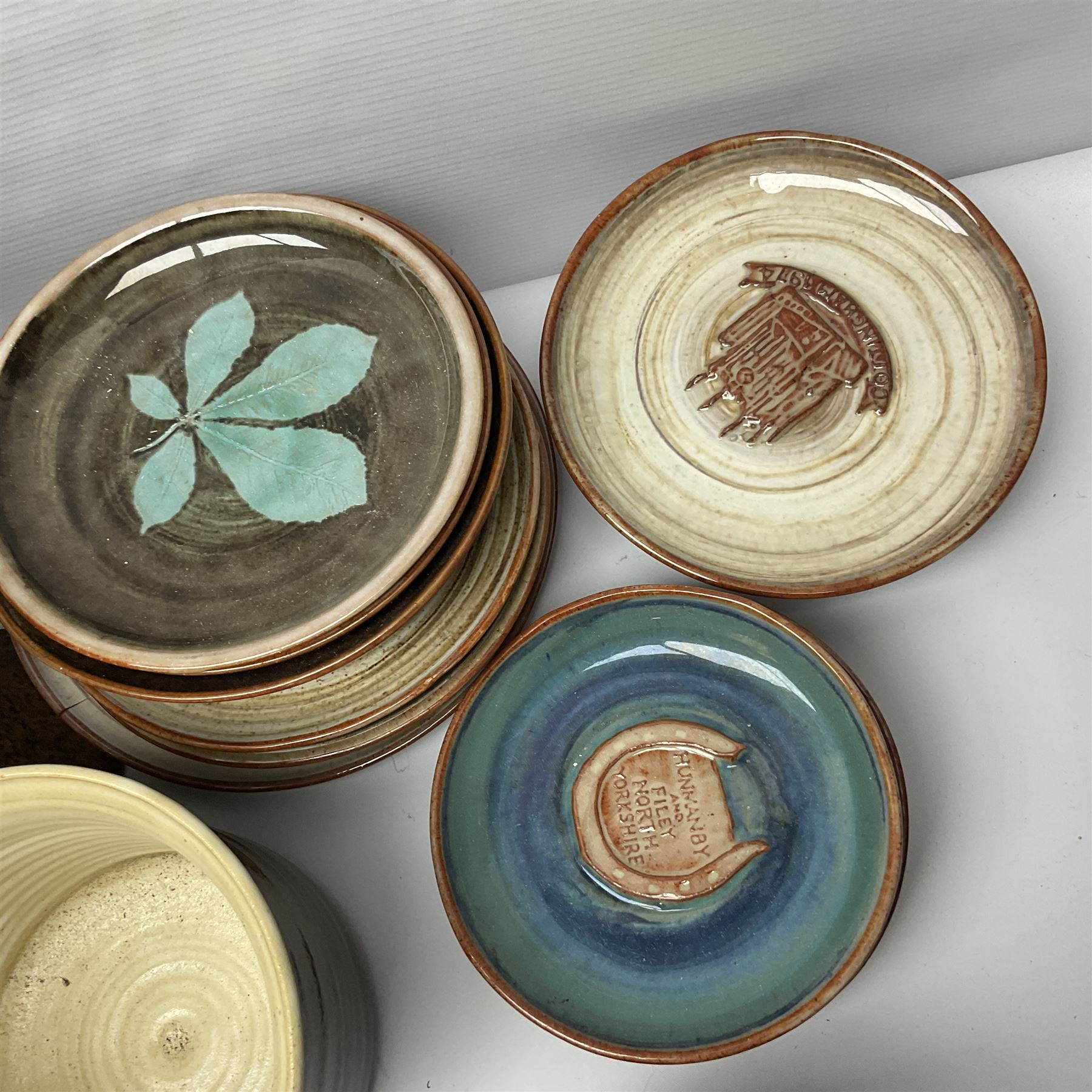 Wold studio pottery tankards, in various colours and relief decoration together with other studio items including vases, jugs and pots 