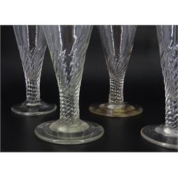 Five late 18th/early 19th century short ale drinking glasses, the part wrythen twist drawn trumpet bowls upon circular feet, tallest H14cm