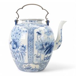 Oversized oriental blue and white teapot, the panels decorated with birds amongst blossomi...