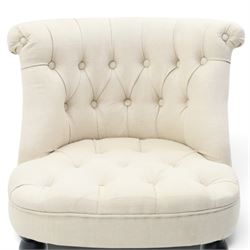 Victorian style upholstered tub chair, buttoned cream fabric back and seat with rolled sides, on ebonised turned front supports with brass castors and splayed rear supports