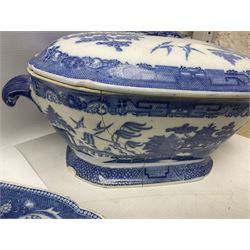Collection of blue and white willow pattern dinnerwares, to include a covered tureen, two meat platters, dinner plates, dishes etc