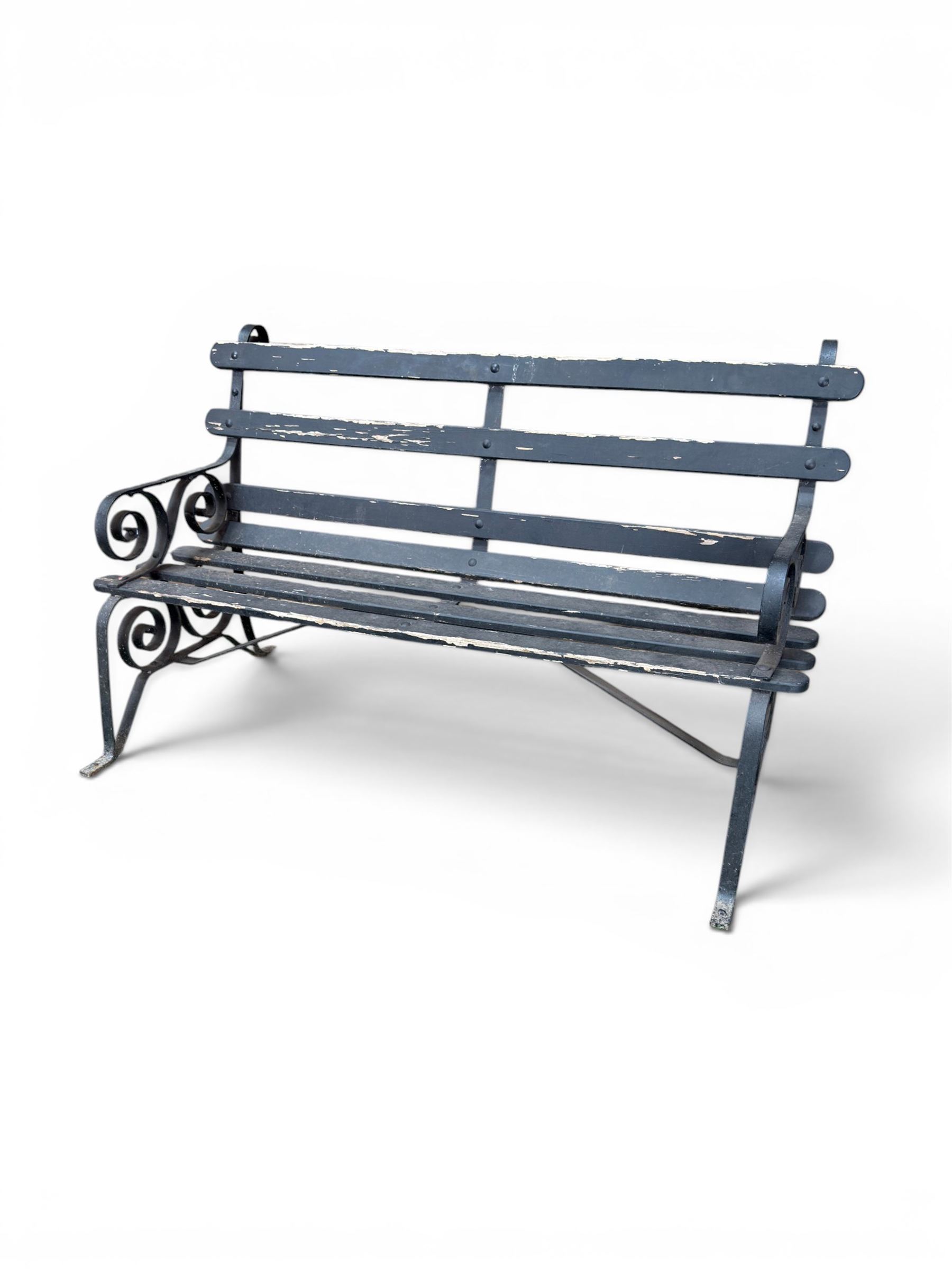 Coalbrookdale - rare pair of wrought iron and slatted wood garden benches, the twin wrought iron strapwork bench-ends formed of four scrolls over splayed feet, number 77 in the Coalbrookdale Castings Catalogue (see illustration)