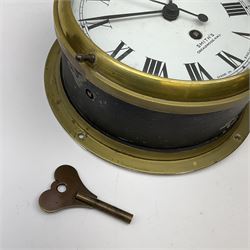 A 20th century Smiths brass cased bulkhead clock with a single train eight-day going barrel movement and balance escapement, white enamel dial with Roman numerals, minute track and five-minute Arabic’s, steel spade hands and centre second hand, dial inscribed “Smiths, Cricklewood N.W, Made in England” brass cast bezel with lock and key, flat glass with silvered sight ring, slow fast balance regulation.
Case diameter 22cm, bezel diameter 19cm.
With key
