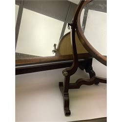 An Edwardian mahogany dressing table mirror, the oval mirror plate in swing frame, upon flared legs linked by stretcher, the frame detailed with turned roundels, H49cm, together with a Victorian mahogany example, H50cm. 