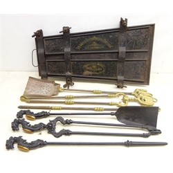  Two cast iron three piece companion sets, one painted black with mythical beast cast terminals, the other with brass Horse head terminals and a Japanned metal Trouser Press   