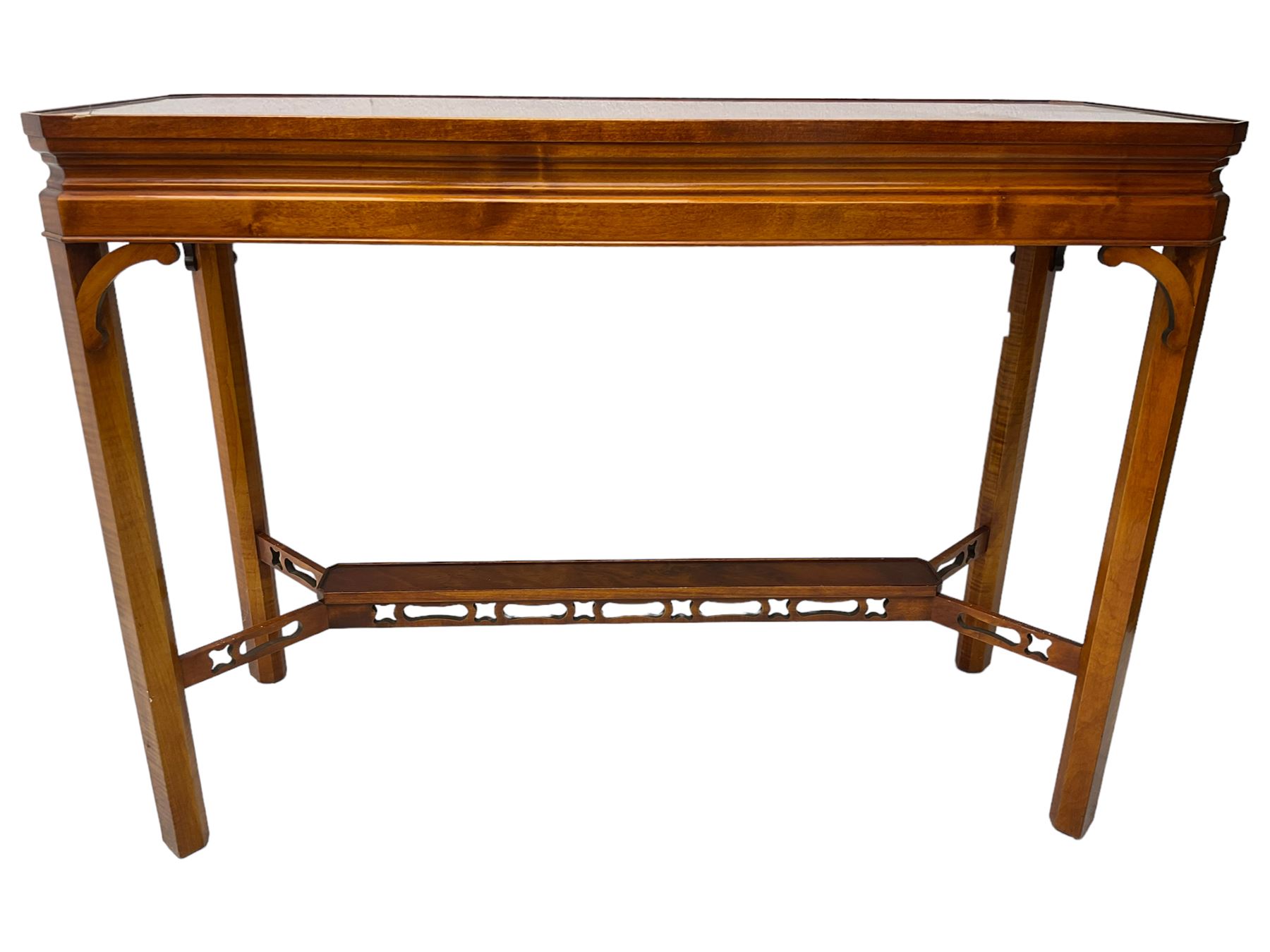 Wade - yew wood console table, rectangular top with canted corners and raised lipped edge, on chamfered square supports united by narrow under-tier