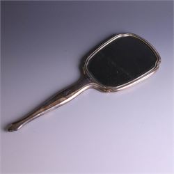20th Century silver mounted dressing table set, comprising hand mirror, clothes brush, hairbrush and comb holder, each with engine turned and engraved floral decoration, three pieces hallmarked Adie Brothers Ltd Birmingham 1964, the comb holder hallmarked Elkington & Co Ltd Birmingham 1965, contained within a fitted tooled leather case