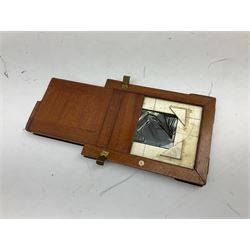 Ensign 'The Sanderson' folding plate camera in mahogany and lacquered brass, field model with canvas wrapped box, two mahogany photographic plates, 'Busch rapid Symmetrical F:8' lens,  and a wooden tripod 