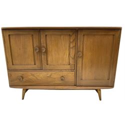 Ercol - elm and beech sideboard, fitted with cupboards and single drawer, enclosed by panelled doors, on splayed tapering feet